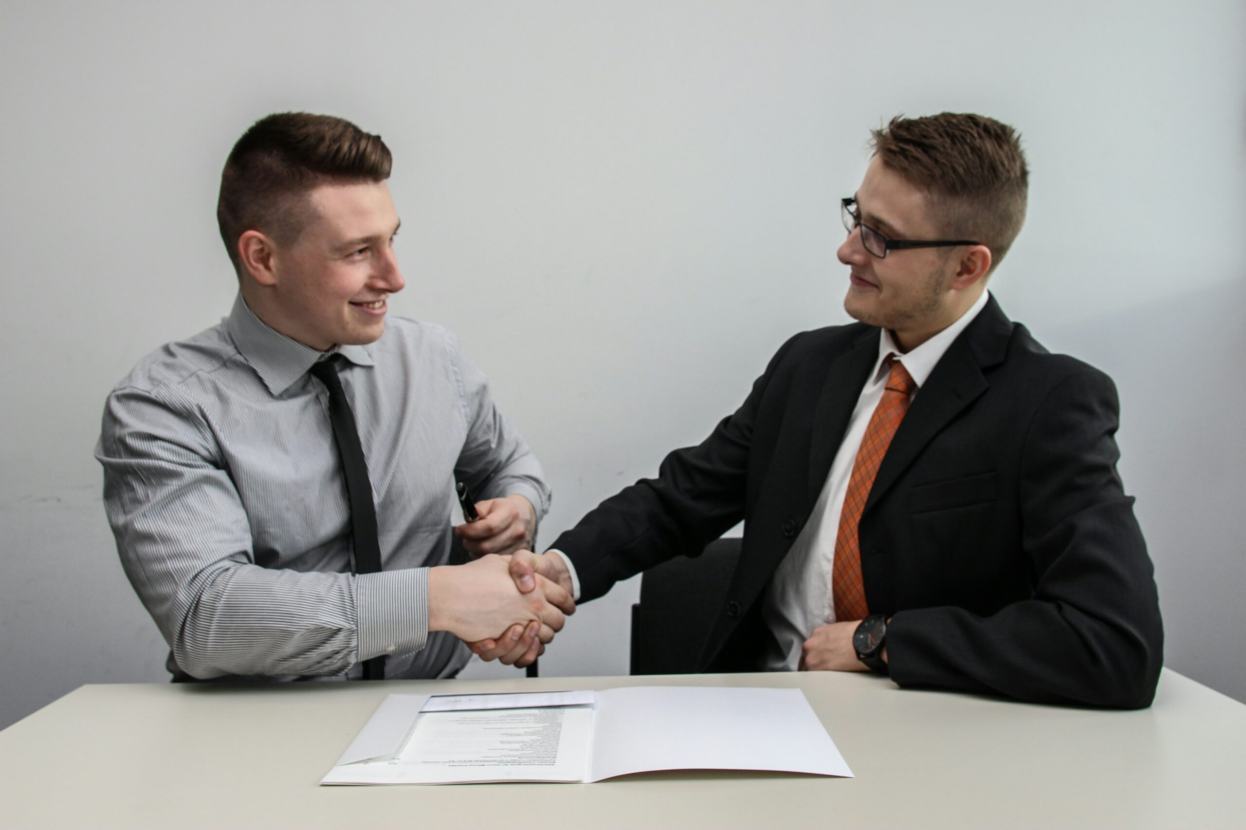 Construction consultants reviewing building codes and shaking hands