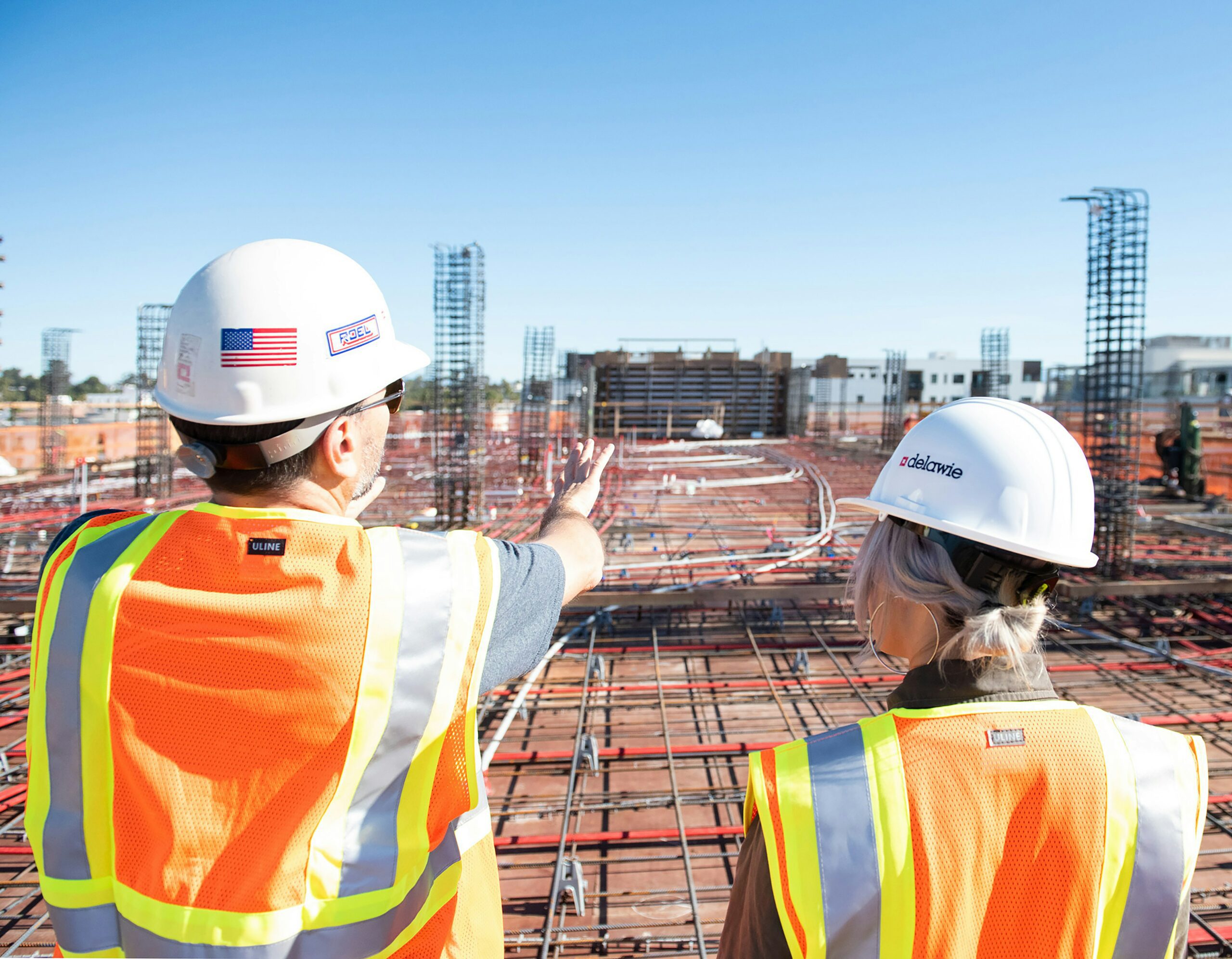 two construction workers looking at a job